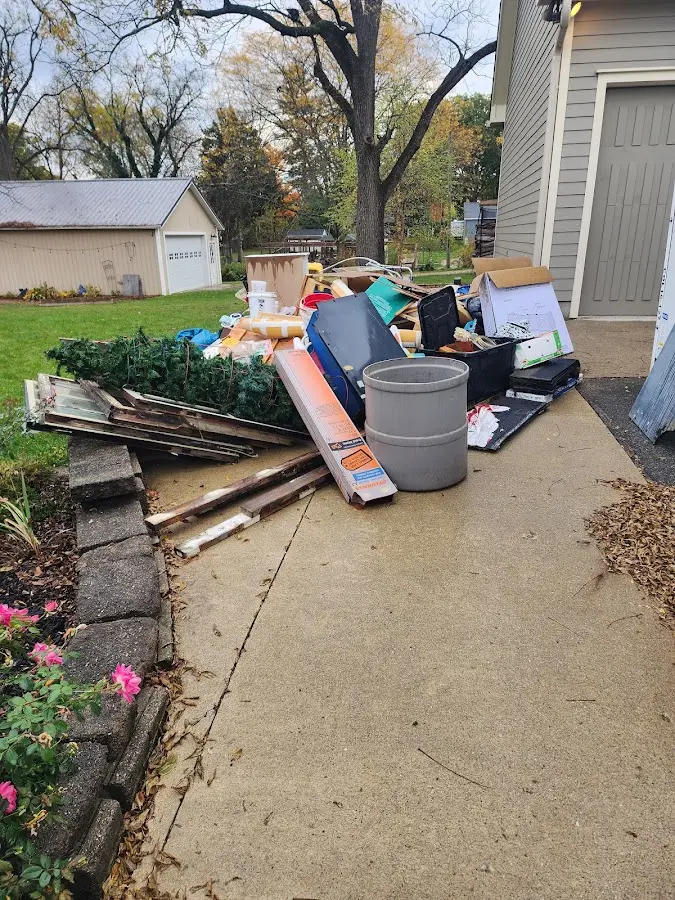 Dumpster being loaded with debris for Estate Cleanout Dumpster Rental in Huntington Beach